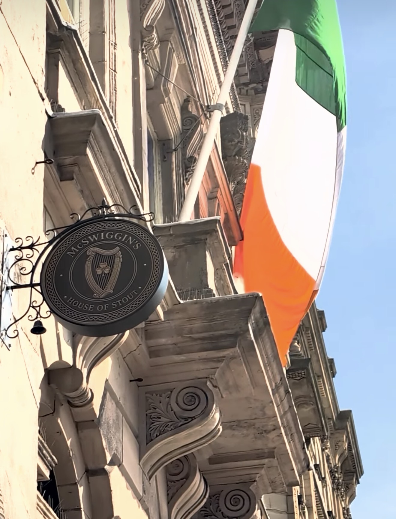 The McSwiggin’s House of Stout hanging sign against a blue sky